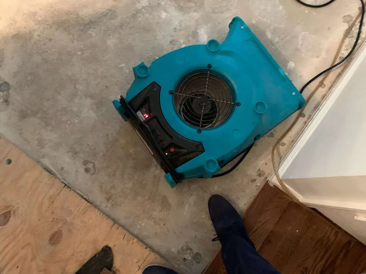 Air mover drying subfloor during Commercial Water Damage Restoration in Goodyear